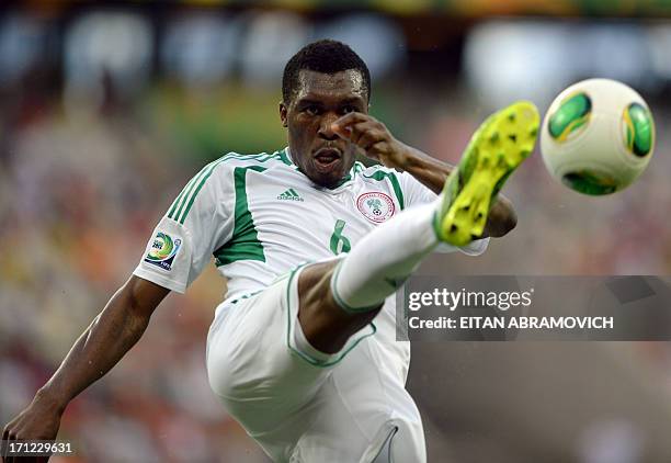 Nigeria's defender Azubuike Egwuekwe kicks the ball during their FIFA Confederations Cup Brazil 2013 Group B football match against Spain, at the...
