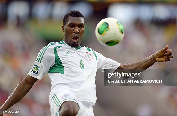 Nigeria's defender Azubuike Egwuekwe eyes the ball during their FIFA Confederations Cup Brazil 2013 Group B football match against Spain, at the...