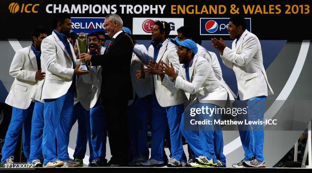 Alan Isaac, President of the ICC presents MS Dhoni, Captain of India with the Champions Trophy, after defeating England in the ICC Champions Trophy...