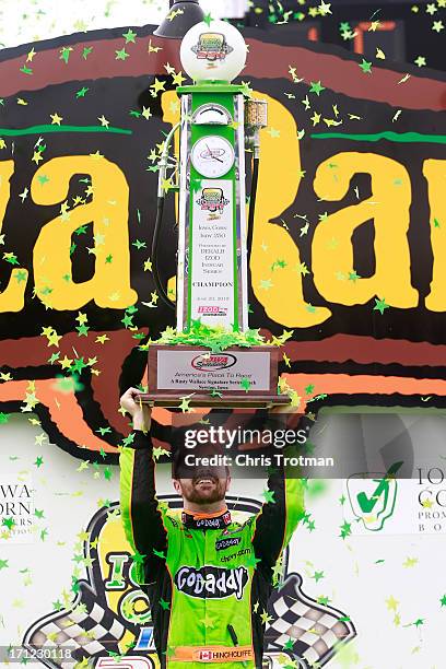 James Hinchcliffe of Canada driver of the GoDaddy Andretti Autosport Chevrolet lifts the trophy in victory lane following his victory in the Iowa...