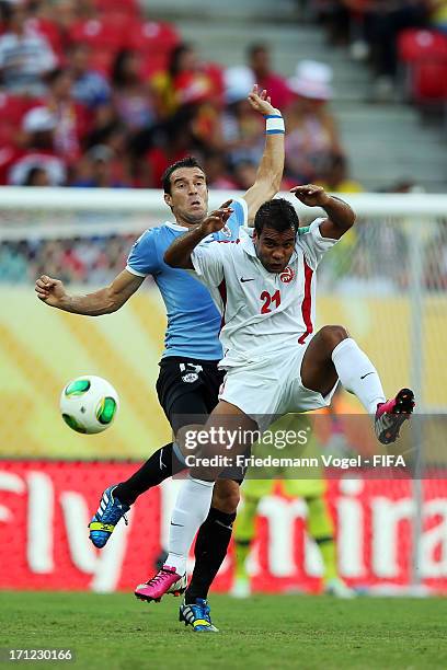 Andres Scotti of Uruguay batteles for the ball with Samuel Hnanyine of Tahiti during the FIFA Confederations Cup Brazil 2013 Group B match between...