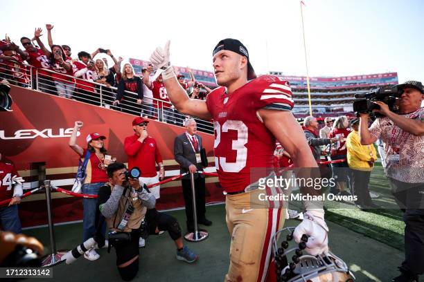 Christian McCaffrey of the San Francisco 49ers celebrates as he walks off the field following an NFL football game between the San Francisco 49ers...