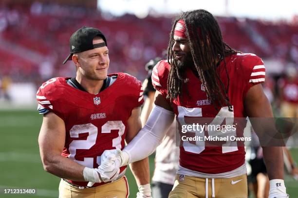 Christian McCaffrey of the San Francisco 49ers celebrates with Fred Warner of the San Francisco 49ers following an NFL football game between the San...