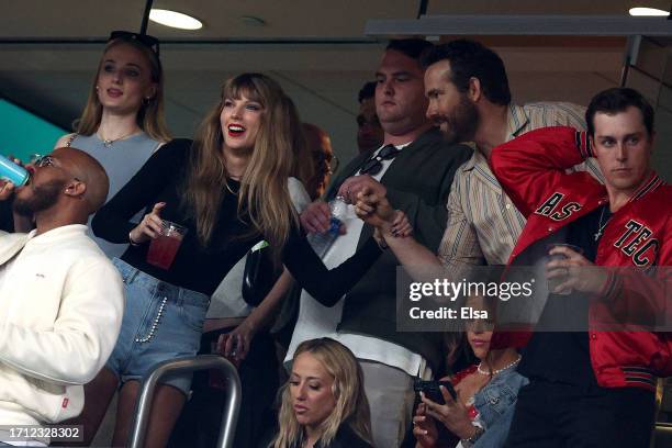 Singer Taylor Swift and Actor Ryan Reynolds talk prior to the game between the Kansas City Chiefs and the New York Jets at MetLife Stadium on October...