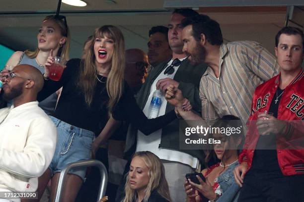 Singer Taylor Swift and Actor Ryan Reynolds talk prior to the game between the Kansas City Chiefs and the New York Jets at MetLife Stadium on October...