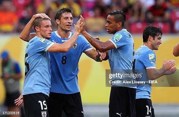 Diego Perez of Uruguay celebrates with Alvaro Pereira and Sebastian Eguren after scoring a goal during the FIFA Confederations Cup Brazil 2013 Group...