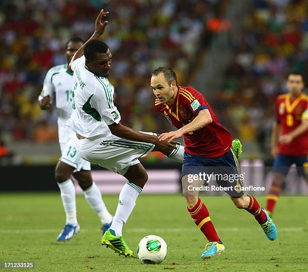 Andres Iniesta of Spain battles for the ball with Azubuike Egwuekwe of Nigeria during the FIFA Confederations Cup Brazil 2013 Group B match between...