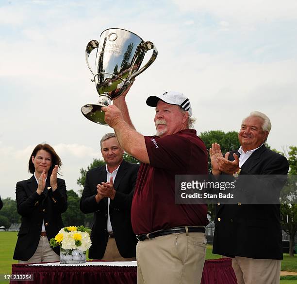 Craig Stadler poses with the winner's trophy on the 18th green after the final round of the Encompass Championship at North Shore Country Club on...