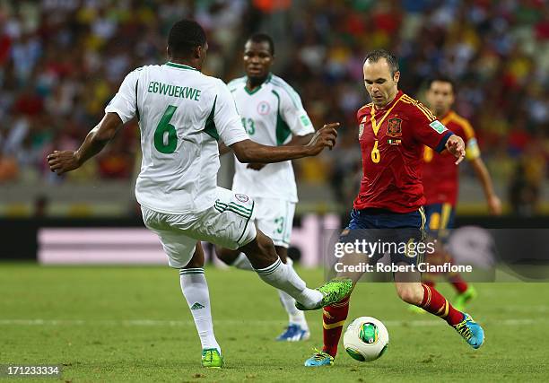 Andres Iniesta of Spain competes for the ball with Azubuike Egwuekwe of Nigeria during the FIFA Confederations Cup Brazil 2013 Group B match between...