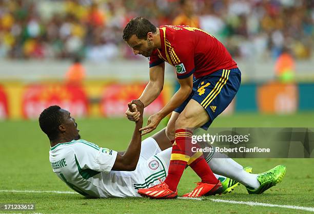 Roberto Soldado of Spain helps Azubuike Egwuekwe of Nigeria to his feer during the FIFA Confederations Cup Brazil 2013 Group B match between Nigeria...