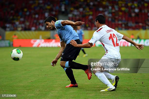 Luis Suarez of Uruguay battles for the ball with Edson Lemaire of Tahiti during the FIFA Confederations Cup Brazil 2013 Group B match between Uruguay...