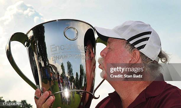 Craig Stadler kisses the winner's trophy on the 18th green after the final round of the Encompass Championship at North Shore Country Club on June...