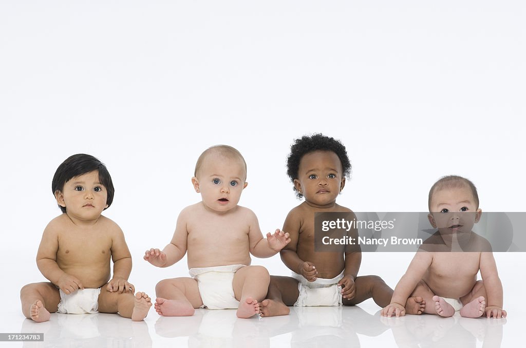 Multi Ethnic Babies Sitting on White.