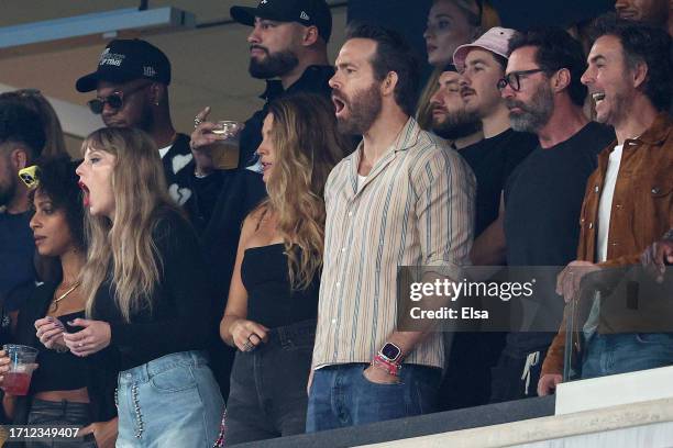 Singer Taylor Swift, Actor Ryan Reynolds and Actor Hugh Jackman cheer prior to the game between the Kansas City Chiefs and the New York Jets at...