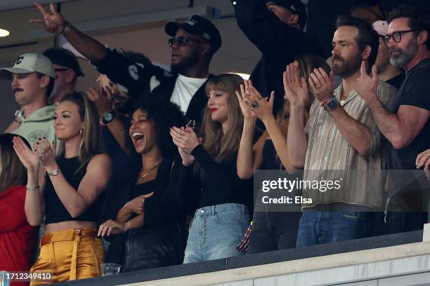 Singer Taylor Swift, Actor Ryan Reynolds and Actor Hugh Jackman cheer prior to the game between the Kansas City Chiefs and the New York Jets at...