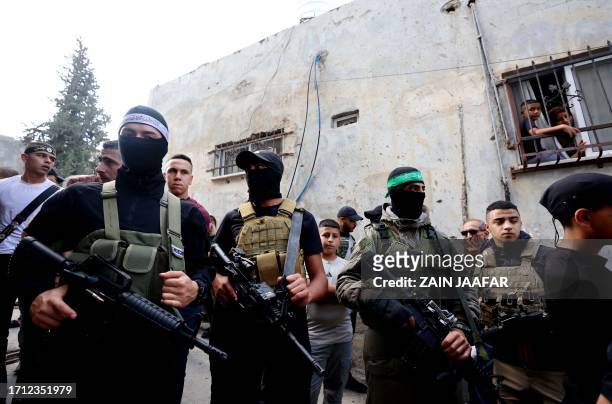 Palestinian militants stand guard during the funeral of 19-year-old Ahmad Awawda who was killed the previous day in clashes with Israeli troops, in...