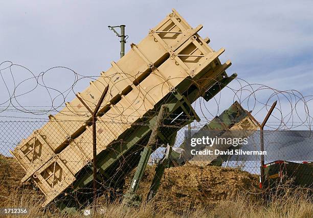 Pair of Patriot missile batteries are deployed in an Israeli army hilltop base as an Air Force jet flies high overhead January 7, 2003 near the town...