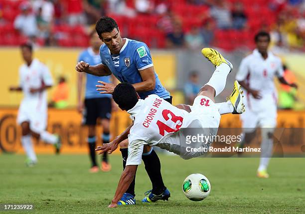 Andres Scotti of Uruguay battles for the ball with Steevy Chong Hue of Tahiti during the FIFA Confederations Cup Brazil 2013 Group B match between...