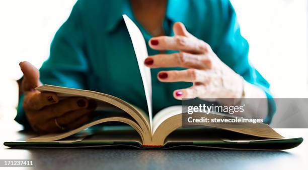 reading book - turning page stock pictures, royalty-free photos & images