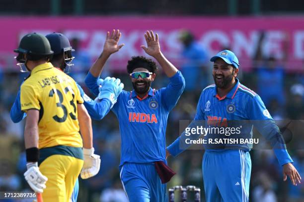 India's Ravindra Jadeja celebrates with teammates after taking the wicket of Australia's Marnus Labuschagne during the 2023 ICC Men's Cricket World...