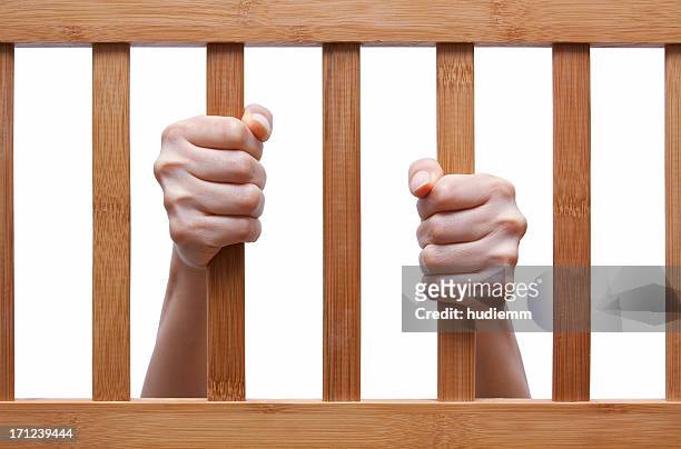 [clipping path!] female prisoner's hands isolated - prison door stock pictures, royalty-free photos & images