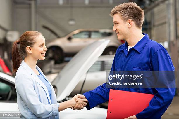 female shaking hands with car mechanic - customer profile stock pictures, royalty-free photos & images