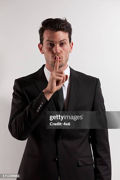 business secret - finger on lips stock pictures, royalty-free photos & images