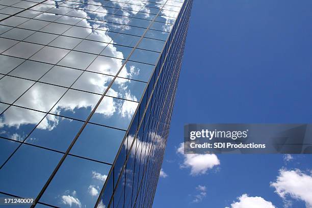 skyscraper reflecting clouds in the sky - directly below sky cloud stock pictures, royalty-free photos & images