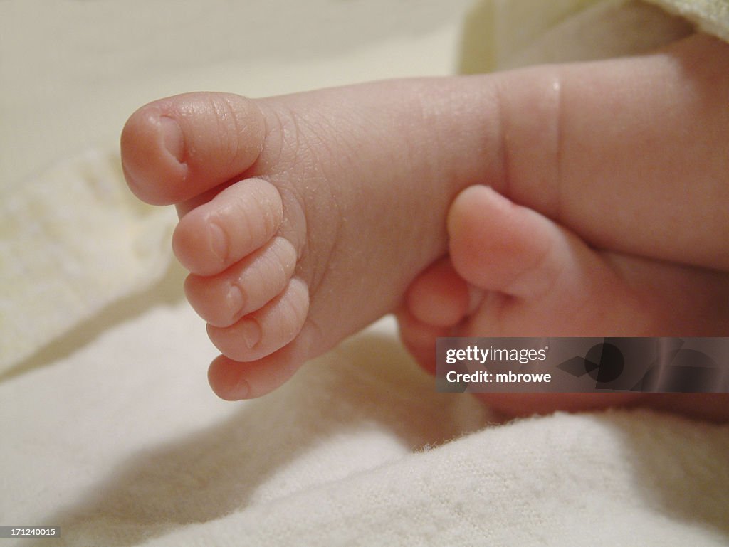 Infant toes sticking out of blanket