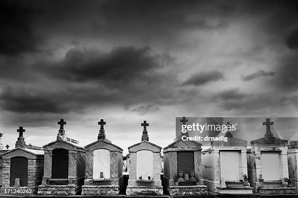 new orleans cemetery under a threatening sky - marble tomb stock pictures, royalty-free photos & images