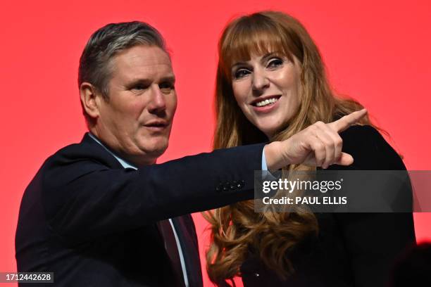 Britain's main opposition Labour Party leader Keir Starmer speaks with Labour Party deputy leader Angela Rayner after she delivers a speech on the...