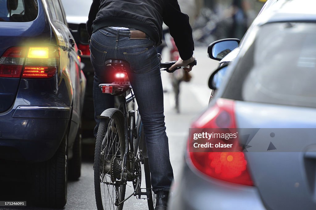 Man on bicycle in traffic