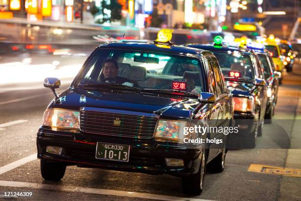 osaka, japan: black taxis stand in a row - taxi stock pictures, royalty-free photos & images