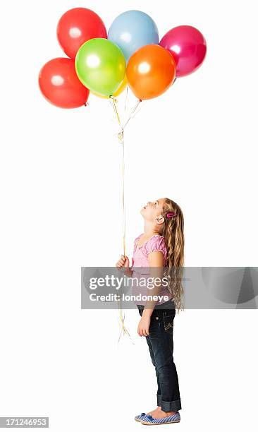 little girl looking at the balloons - isolated - kids side view isolated stockfoto's en -beelden