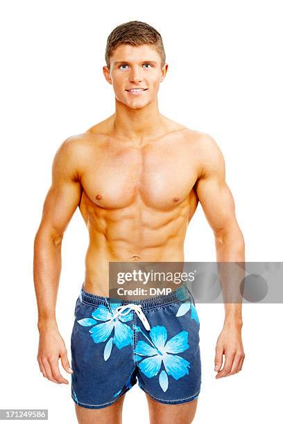 handsome young man in swim shorts - zwembroek stockfoto's en -beelden