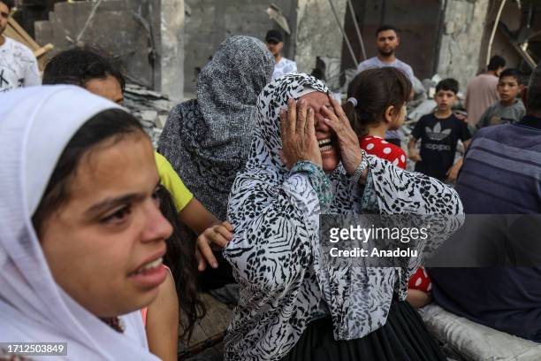 Woman reacts after Israeli fighter jets destroyed a building following the Operation Al-Aqsa Flood launched by Hamas in Rafah, Gaza on October 08,...