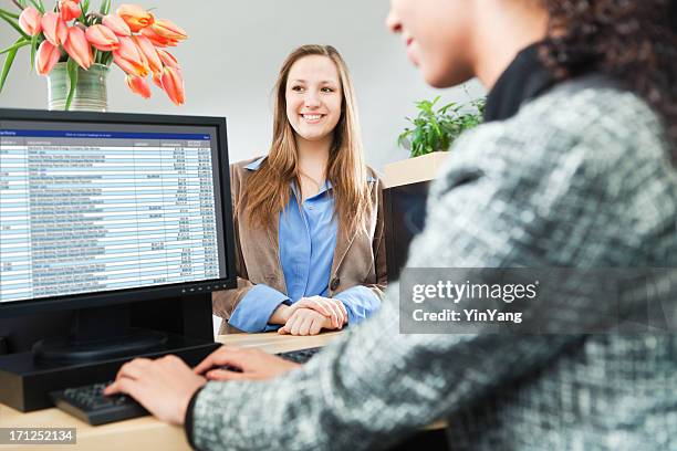 customer at banking counter window making transaction with teller hz - bank counters stock pictures, royalty-free photos & images