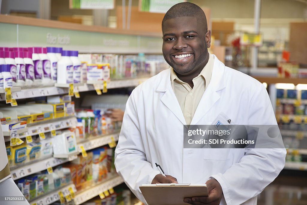 Happy pharmacist in the pharmacy aisle