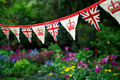 Union Jack British Flag Bunting Hangs Across English Garden