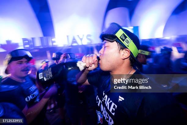 Hyun Jin Ryu of the Toronto Blue Jays celebrates clinching a playoff berth in the locker room, after the final MLB game of the season against the...