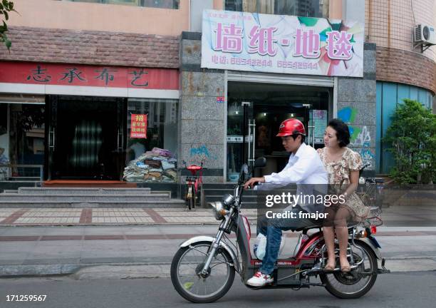 lady on a bike - haikou stockfoto's en -beelden