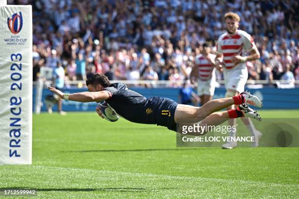 Argentina's left wing Mateo Carreras dives to score a try during the France 2023 Rugby World Cup Pool D match between Japan and Argentina at the...