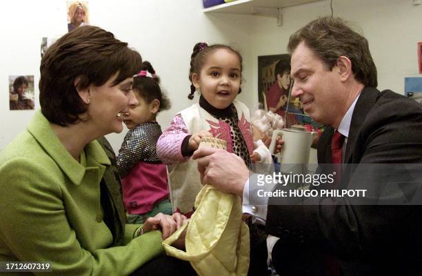 British Prime minister Tony Blair and wife Cherie plays with adopted sisters 4 year old Gemma and 3 year old Ruth 21 December 2000, at Coram family...
