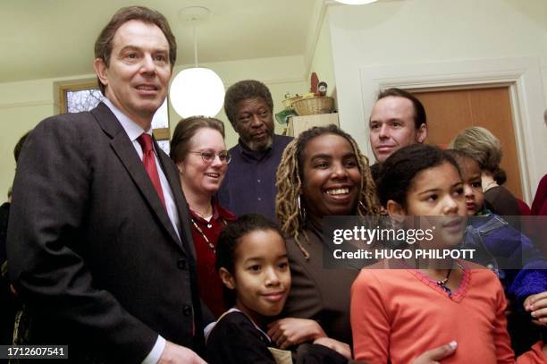 British Prime minister Tony Blair poses with parents and adopted children 21 december 2000, at Coram family centre in London. Mr Blair has taken a...