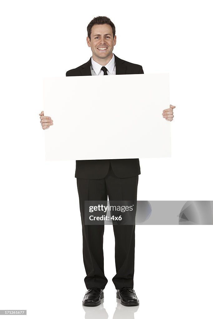 Businessman holding a placard