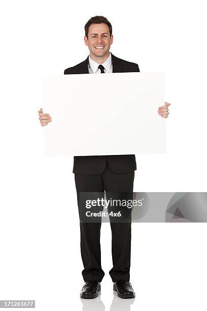 businessman holding a placard - man placard stock pictures, royalty-free photos & images