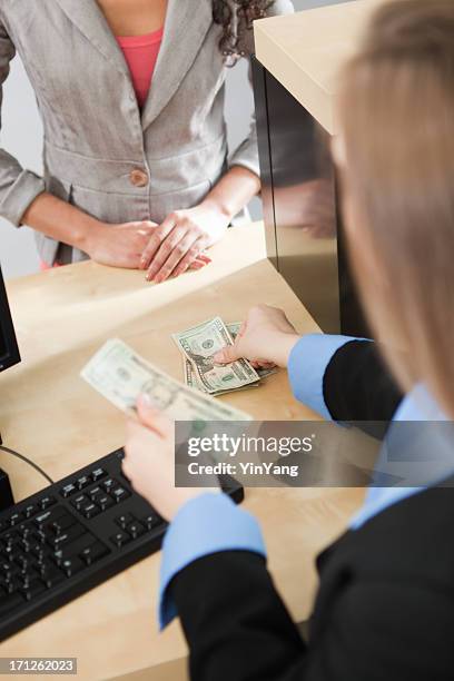 bank employee transacting with a female customer - inside of a bank stock pictures, royalty-free photos & images