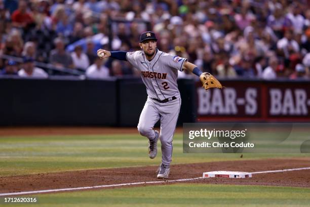 Alex Bregman of the Houston Astros throws to first base during the game against the Arizona Diamondbacks at Chase Field on September 30, 2023 in...