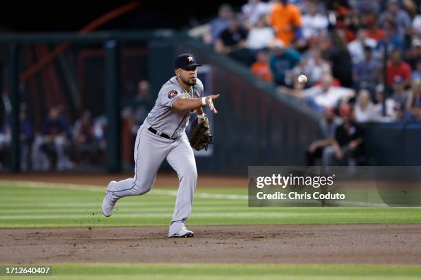 Jose Abreu of the Houston Astros tosses the ball to first base during the game against the Arizona Diamondbacks at Chase Field on September 30, 2023...