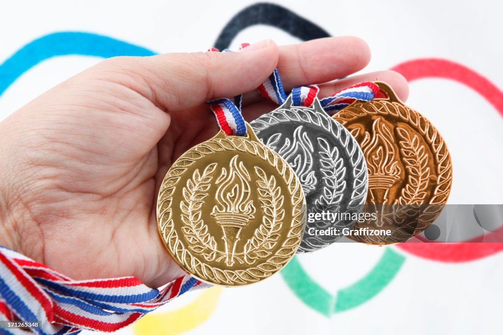 Three medals with Olympic Flag